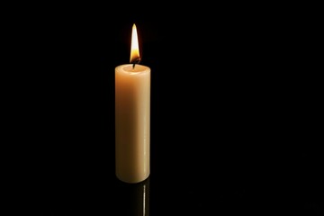 Burning candle on a dark background