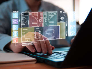 Close-up engineer working on IoT smart/automated home, design and plan to setup and install the intelligence system. Laptops on wood table, finger touching on laptop keypad.