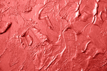 Abstract pink coral texture of surface covered with putty. Wall background covered with putty