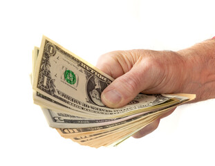 A male hand holding a wad of dollar bills isolated on white