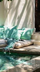 Arranges a quiet reading nook by the pool, with aquacolored cushions and soft throws, making it the perfect spot for relaxation and solitude