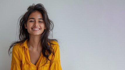 Fototapeta premium Indian woman wearing yellow shirt smiling laugh out loud isolated on grey