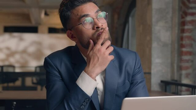 Arabian Indian thoughtful business man thinking problem solution think idea ponder question serious pensive male guy businessman consider decide search answer choose planning computer work in office
