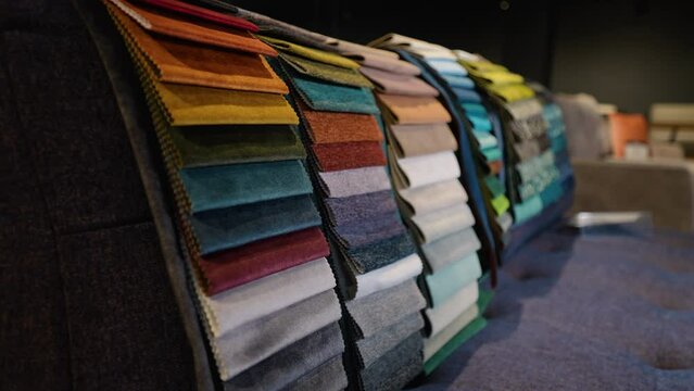 Fabric and textiles samples in a factory shop or store. Different colors and patterns on the market