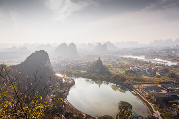 River bend surrounded by the city buildings and limestone rocks in Guilin, China