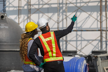 Construction civil engineer man and woman African American checking quality of work in construction...