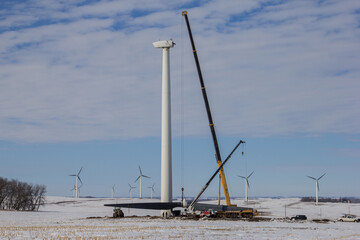 crane taking down wind turbine blades