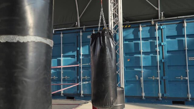 Empty boxing and martial arts area on street gym with many punching bags. Urban outdoor space for exercise, combat and kicking sports with punch sacks. Self-made site for boxing training. 