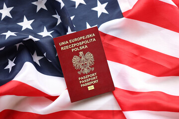 Poland passport on United States national flag background close up. Tourism and diplomacy concept