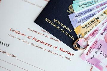 Indian Certificate of registration of marriage blank document and wedding ring with rupiah money on...