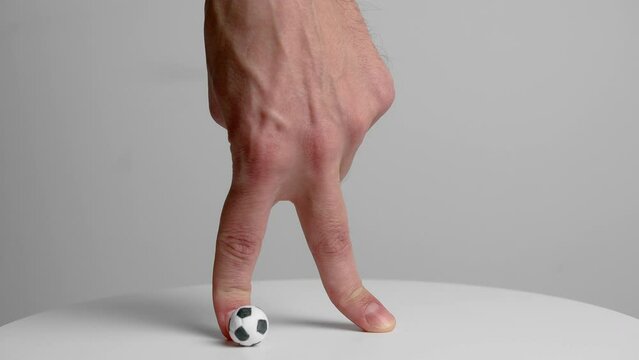 Fingers Walking a Mini Soccer Ball - Playful Concept