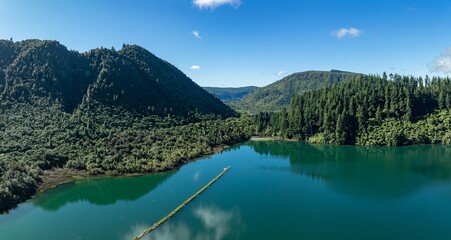 Calm water and forest in of the Blue Lake, Rotorua, Bay of Plenty, New Zealand.