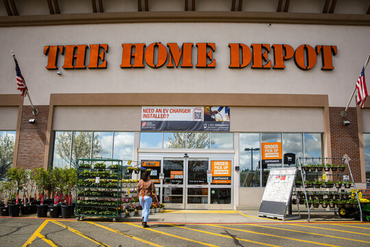 Auburn, CA, U.S.A. - March 25, 2024: Photo of the front entrance of a Home Depot that includes a sign about EV charger installation.  Many electric car owners decide to purchase their own chargers.