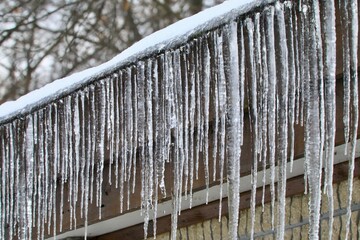 Icicles hanging from the side of a house