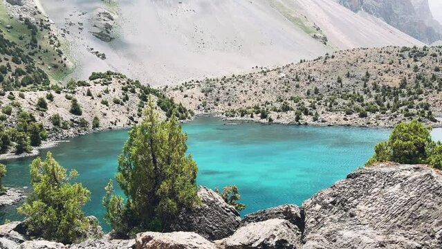 The Alaudin (Chapdara) lakes, lying at an altitude of 2800 m, are considered one of the most beautiful lakes of the Fan Mountains. Turquoise mountain lake. Pamiro-Alai. Tajikistan, Pamir 4K