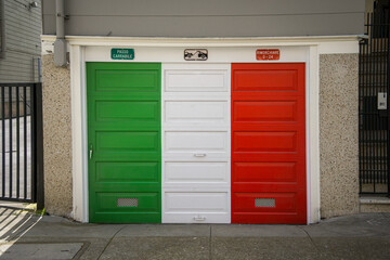 Photo of a garage door painted in the Italian flag colors of red, white and green in a historically Italian neighborhood.