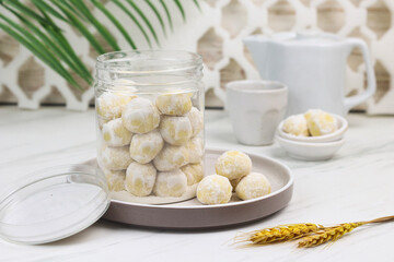 Kue putri salju or snow white cookies, popular hari raya cookies in Indonesia, baked and powdered with icing sugar. Special background for ramadan and eid mubarak. 