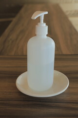 Disinfectant bottle on brown wooden table background