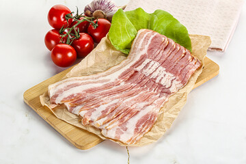 Sliced pork bacon oved board