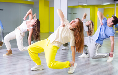 Teen girl in sportswear dancing modern dances in dance studio..