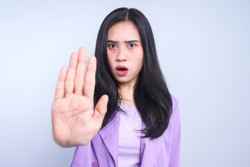 Serious woman showing no hands gesture, demonstrating denial sign, rejecting something unwanted.