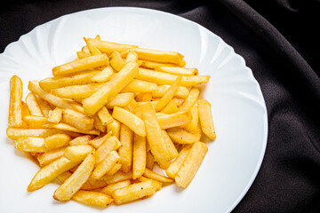 french fries on the white plate - 787803903