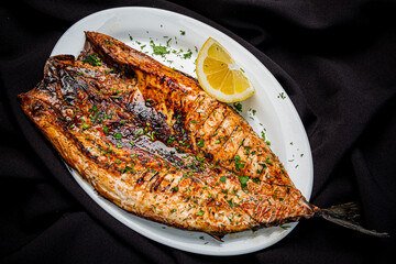 grilled fish on the white plate - 787804501