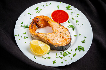 salmon steak with sauce and lemon - 787805101