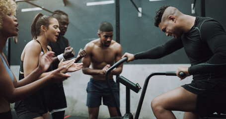 Group, exercise bike and motivation for man in gym with applause, cheers and diversity for fitness. People, friends and team with support, connection or cycling for health, workout and wellness club