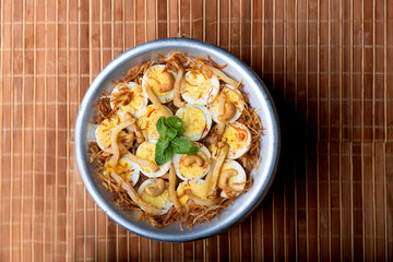 Egg biryani with boiled egg and spice garnish.