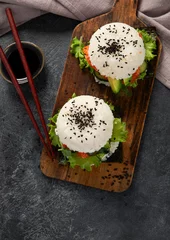  Asian sushi burger, soy sauce, chopstick on dark background. Trendy hybrid food © bit24