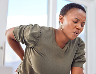 Back pain, emergency and black woman in office with joint, problem or tension, inflammation or...