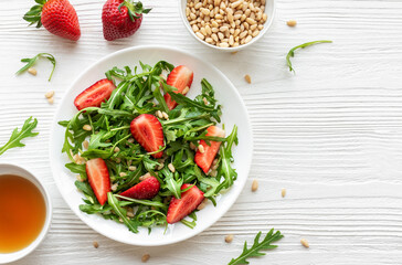 Fresh Strawberry Arugula Salad With Pine Nuts Served on a Bright Day