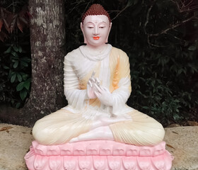 Serene Buddha Statue in Meditative Pose Amongst Nature