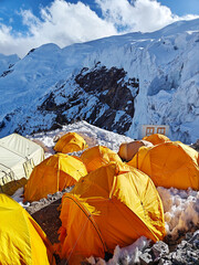 Himalayan mountain camp in Nepal, colorful tents, glacier, and clouds