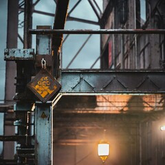 A moody industrial background with aged metal structures and faded signage, capturing the industrial heritage of urban landscapes
