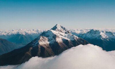 Beautiful landscape of snowy mountain peaks above the clouds.