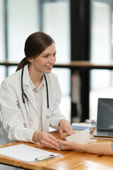 Woman patient visiting female doctor at clinic office.