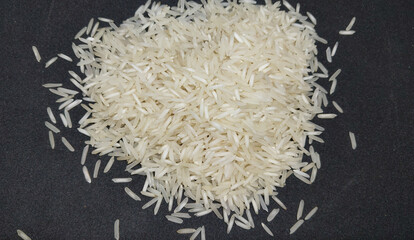 Basmati white rice on black background. Close up, top view. 