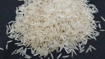 Basmati white rice on black background. Close up, top view. 