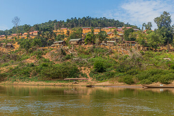 Village above waters of Nam Ou 3 reservoir, Laos