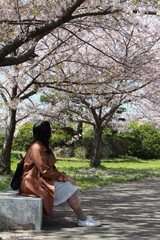 person sitting on a bench in the park