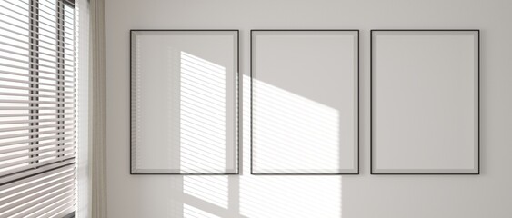 Three black photo frames mockup on a white wall with sunlight shining through the blinds, 3D illustration.