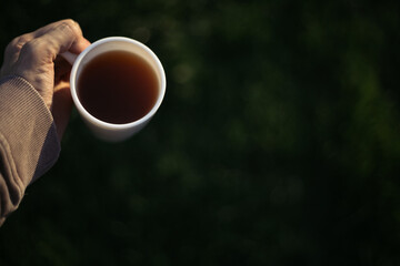 a man holds a mug of coffee, tea and moves