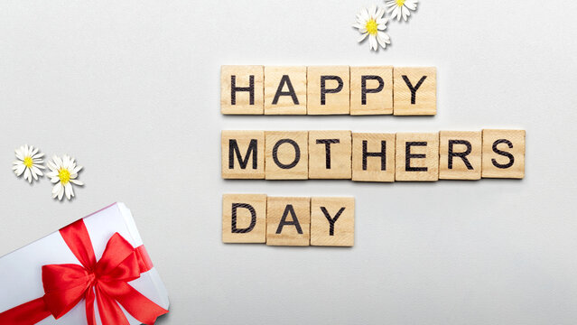 A row of wooden cubes with Happy Mother's Day text and a gift box