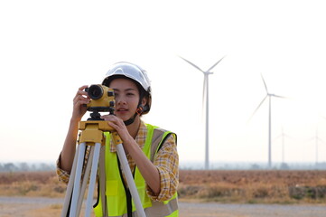  female engineer Survey the area to install wind turbines for electrical energy production..Renewable energy, clean energy or environmental conservation concepts.