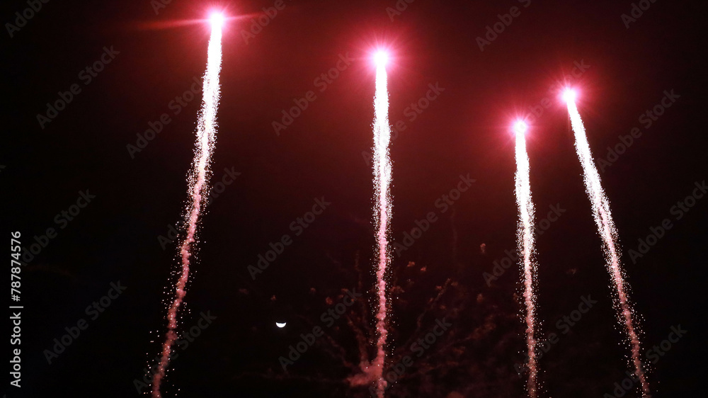 Wall mural fireworks in the sky. beautiful array of red fireworks against a half-moon night sky with copy space