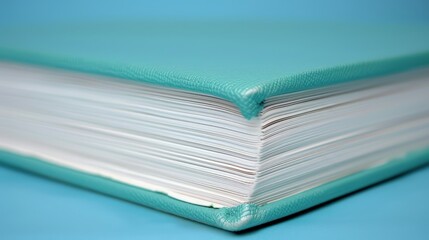   A stack of folded papers atop a blue counter, adjacent to a tablecloth and surface, both in hue of blue