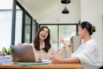 Smiling businesswoman listens attentively during a productive team meeting in a contemporary office setting.