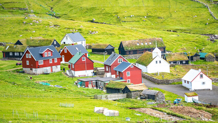 Mykines, Faroe Islands. Panoramic view of Mykines island village, bird watching destination for puffins. Traditional houses with turf roofs